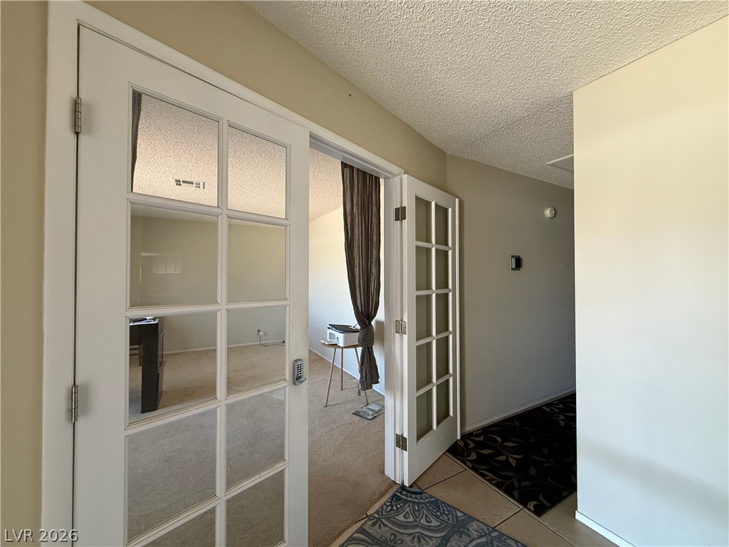 6491 West Viking Road Las Vegas, NV 89103 - Photo 7 of 20 Foyer entrance with French doors leading to Den / office