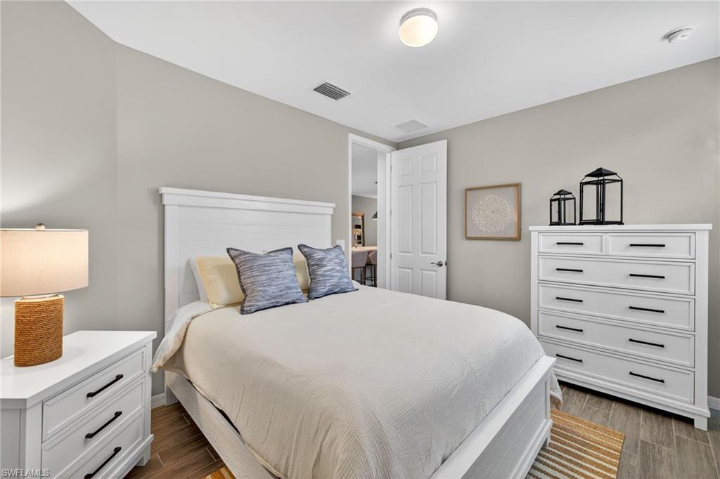14567 Edgewater Circle Naples, FL 34114 - Photo 24 of 43 a bedroom with a bed and a closet
