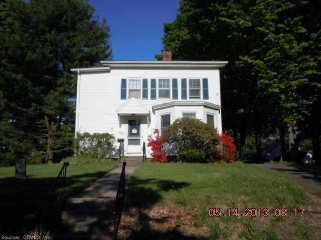 a front view of house with a garden