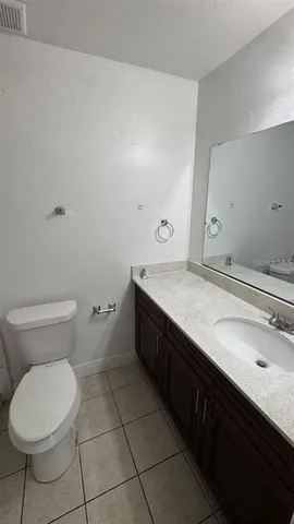 a white toilet sitting next to a shower curtain