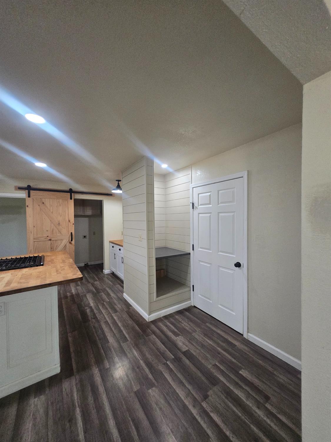 10601 Lime Kiln Road Grass Valley, CA 95949 - Photo 18 of 79 Pantry in front of white door. Behind barn doors is the laundry area.