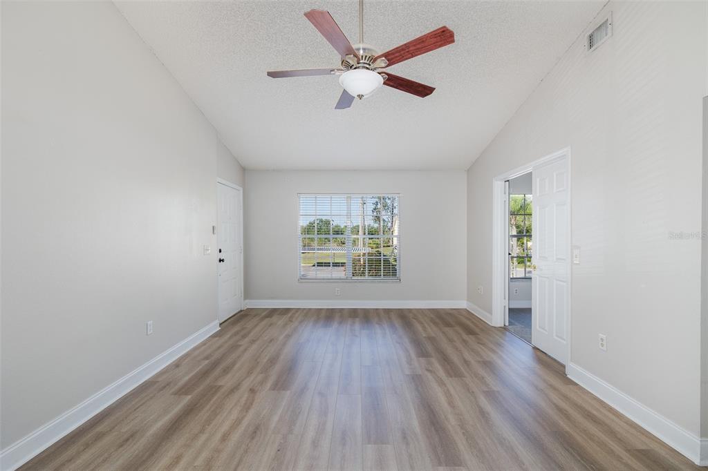 7900 Hardwick Drive, Unit 827 New Port Richey, FL 34653 - Photo 5 of 27 wooden floor in an empty room with a window