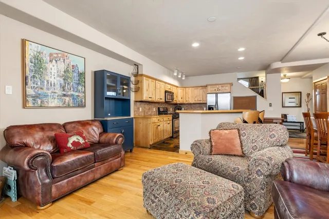 a living room with furniture and kitchen view