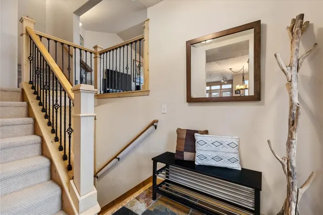 a view of staircase with wooden floor and a rug