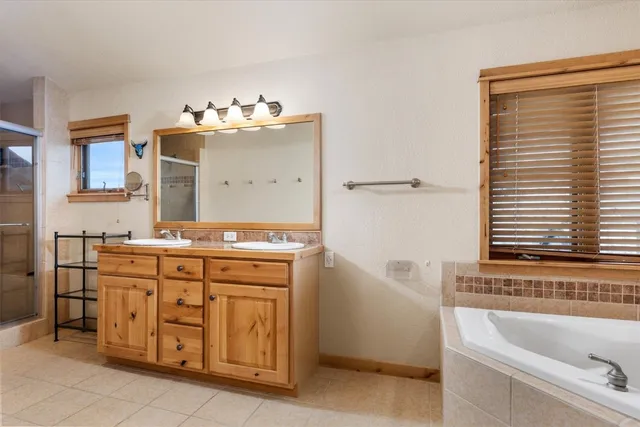 a bathroom with a tub sink and mirror
