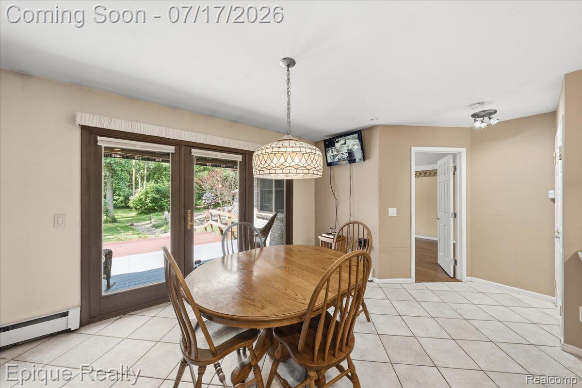 22520 Waltz Road New Boston, MI 48164 - Photo 22 of 43 Dining area featuring white tile flooring and a decorative chandelier