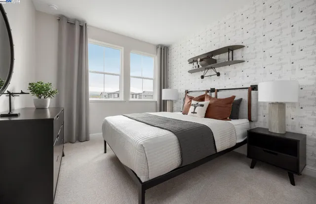 a bedroom with a bed and a potted plant