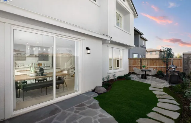 a view of a house with backyard porch and sitting area