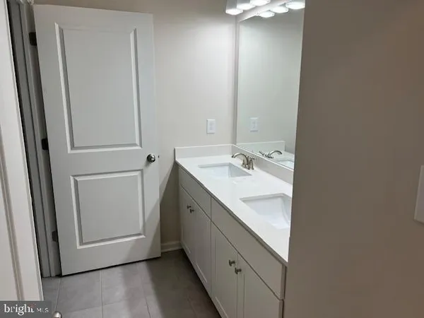 a bathroom with a sink a mirror and a vanity