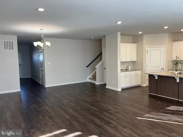a view of kitchen with cabinets and wooden floor