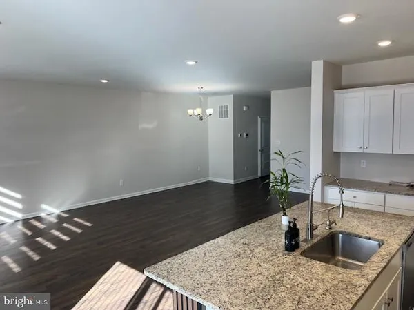 a kitchen with sink and refrigerator