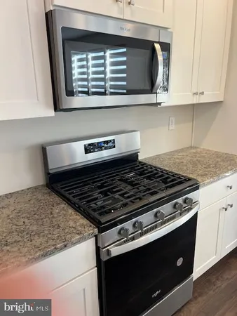 a stove top oven sitting inside of a kitchen