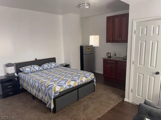 a bedroom with a bed and cabinets