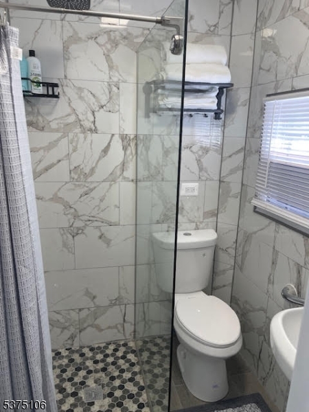 2420 East Edgar Road Linden, NJ 07036 - Photo 6 of 9 a white toilet sitting next to a shower