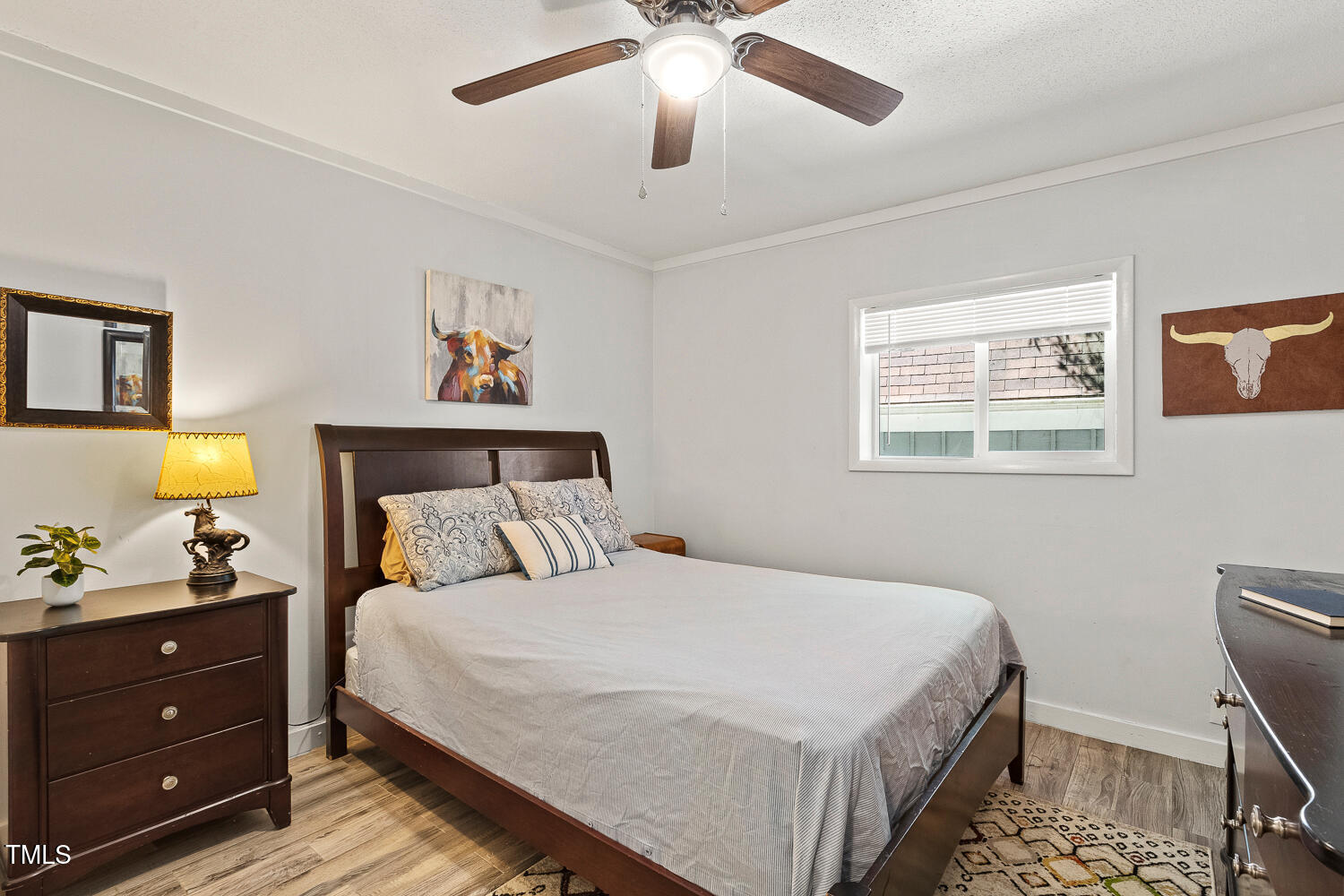 7002 Longstreet Drive, Unit C Raleigh, NC 27615 - Photo 17 of 31 a bedroom with a bed and a chandelier