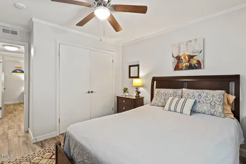 a bedroom with a bed and a chandelier