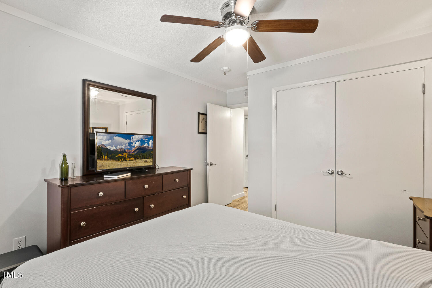 7002 Longstreet Drive, Unit C Raleigh, NC 27615 - Photo 20 of 31 a bedroom with a bed and a flat screen tv