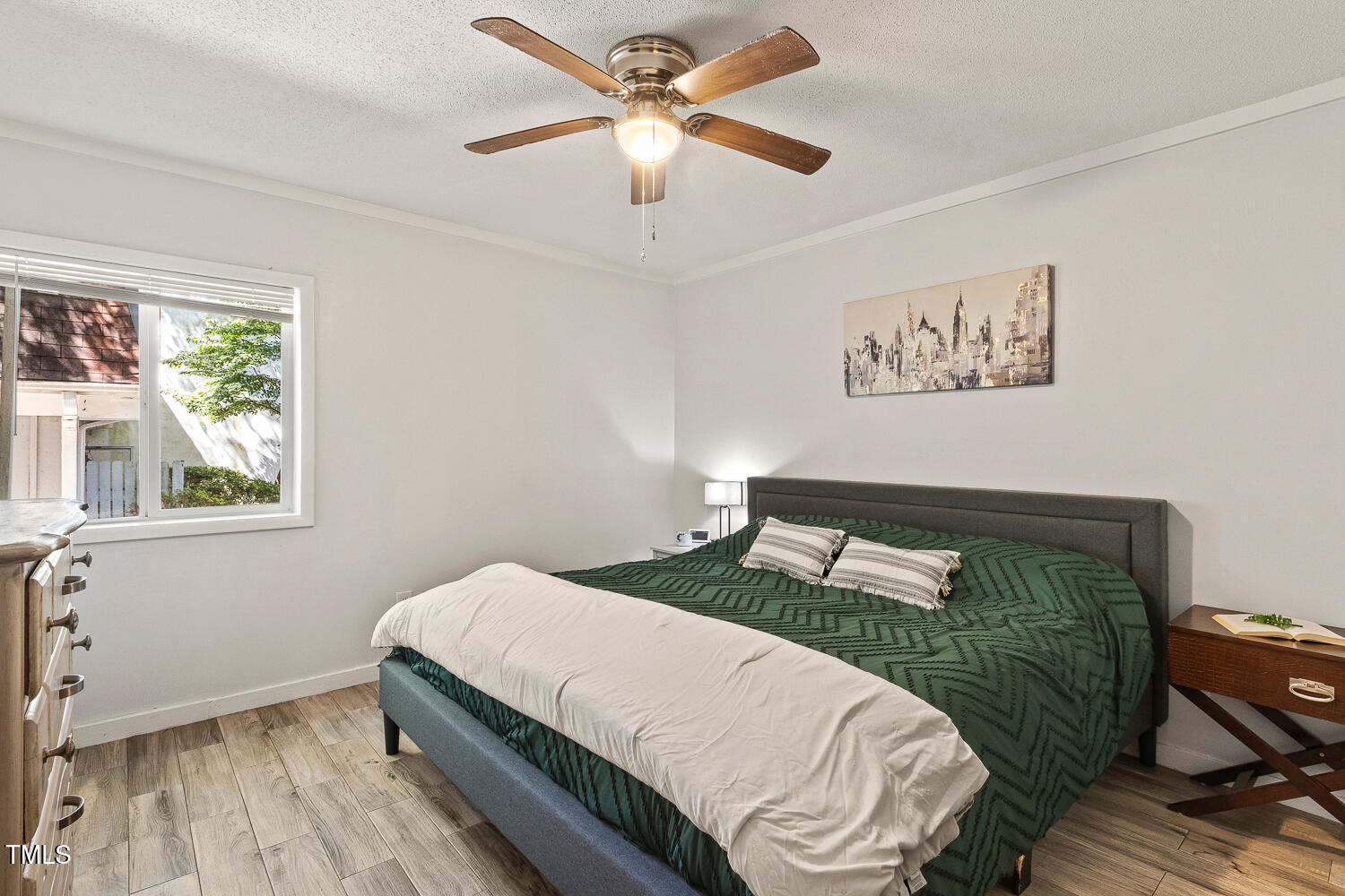 7002 Longstreet Drive, Unit C Raleigh, NC 27615 - Photo 22 of 31 a bedroom with a bed and a window