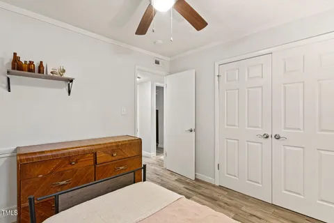 a room with a dresser and a chandelier