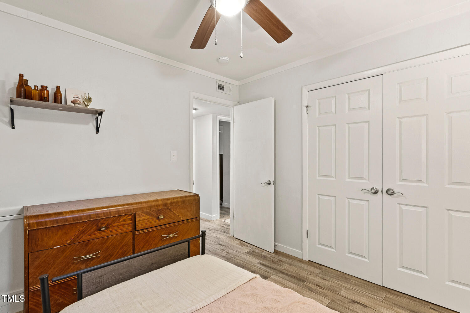 7002 Longstreet Drive, Unit C Raleigh, NC 27615 - Photo 26 of 31 a room with a dresser and a chandelier
