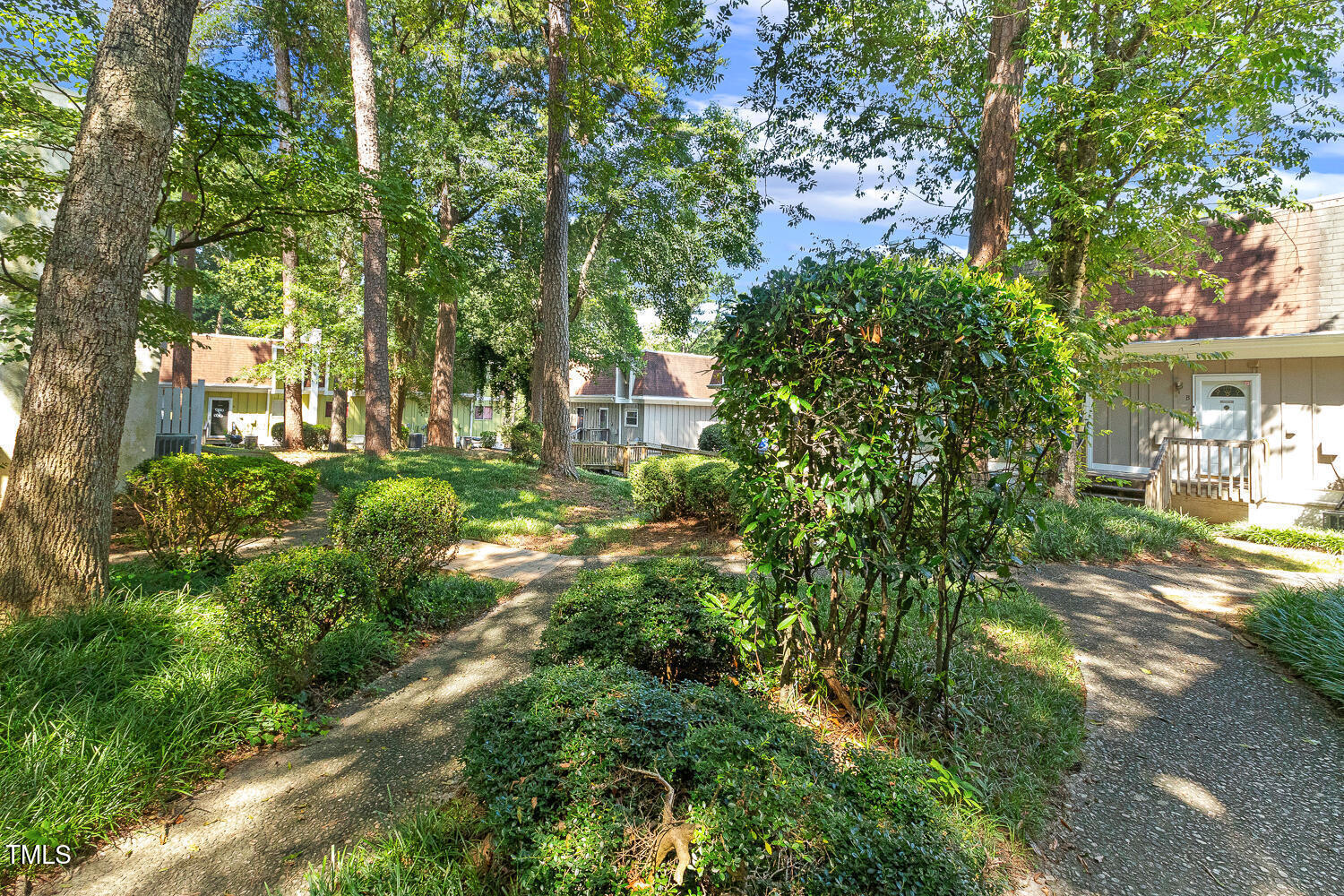 7002 Longstreet Drive, Unit C Raleigh, NC 27615 - Photo 28 of 31 a view of a yard with plants and large trees