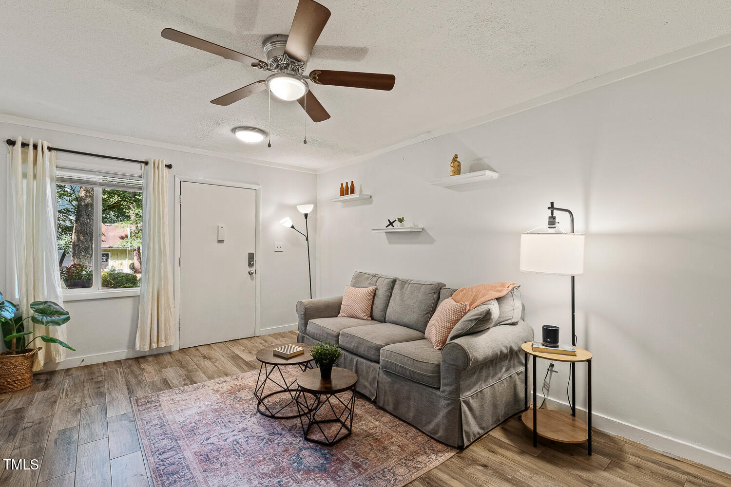 7002 Longstreet Drive, Unit C Raleigh, NC 27615 - Photo 4 of 31 a living room with furniture and a window