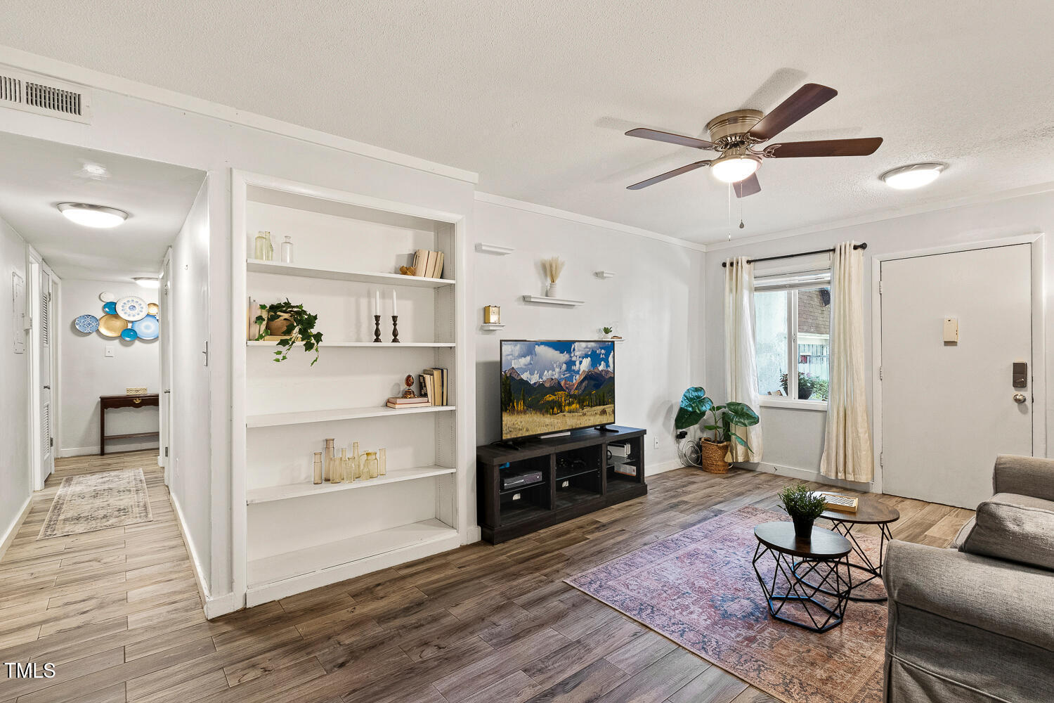 7002 Longstreet Drive, Unit C Raleigh, NC 27615 - Photo 5 of 31 a living room with furniture and a flat screen tv
