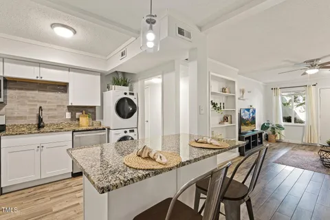 a kitchen with granite countertop lots of counter top space and furniture