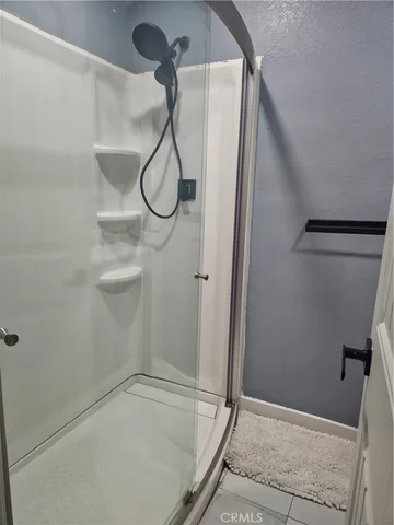 a bathroom with a glass shower door