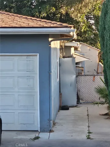 a side view of a house with a wooden bench