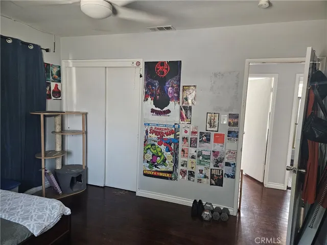 a view of a closet area with wooden floor