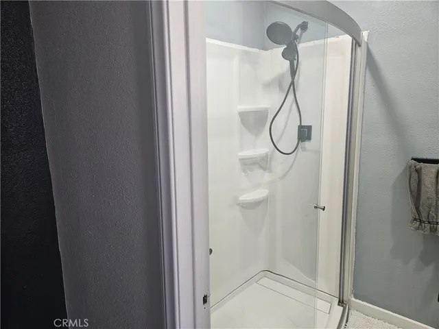 a bedroom with a bed and a mirror