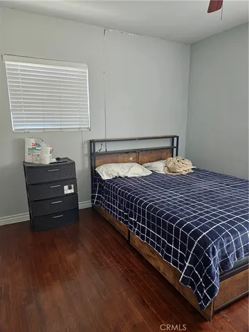 a bed sitting in a bedroom next to a window