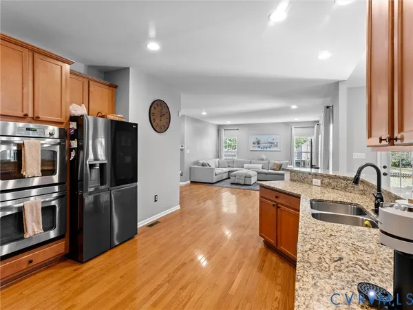 a dining room with furniture and wooden floor