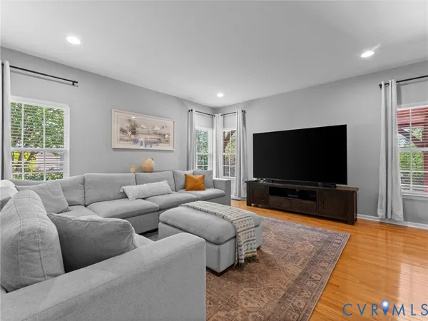 a spacious bedroom with a bed a ceiling fan and a couch