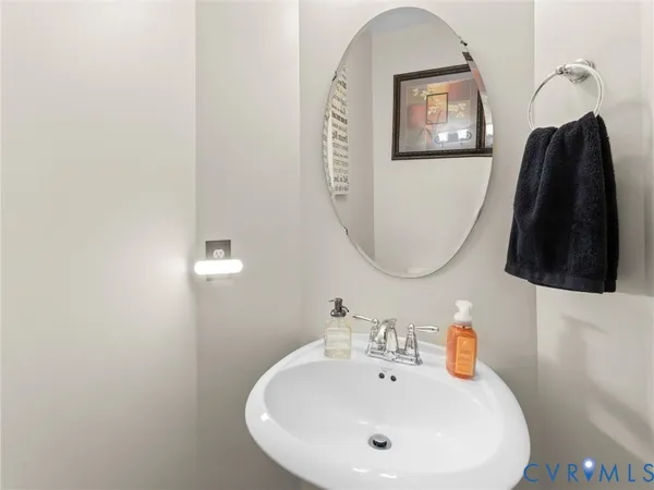 a spacious bathroom with a double vanity sink a large mirror and a bathtub