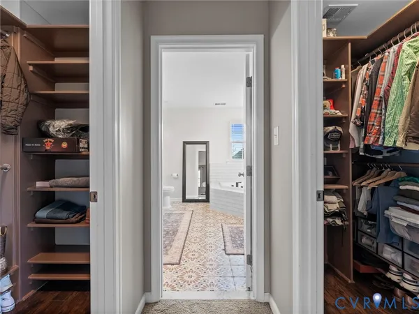 a view of a hallway with a livingroom and stairs