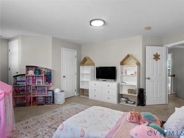 a bedroom with a bed and flat screen tv