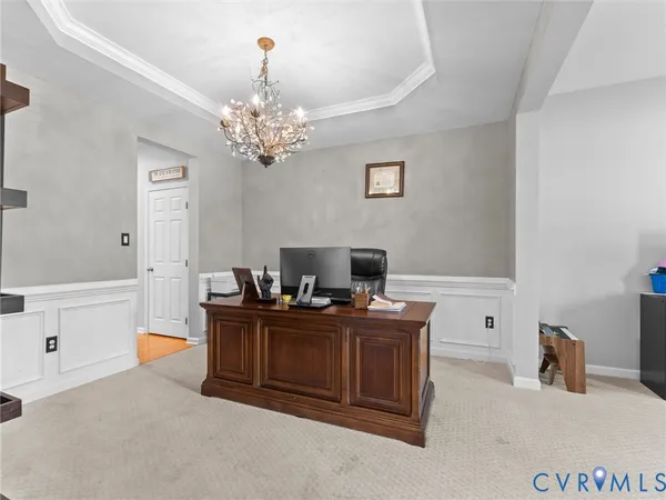 a view of a dining room with furniture and a chandelier