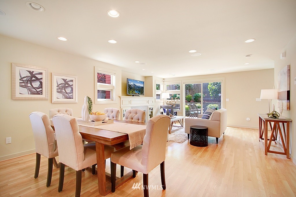 7757 Sand Point Way Northeast, Unit A Seattle, WA 98115 - Photo 12 of 25 a view of a dining room with furniture window and wooden floor