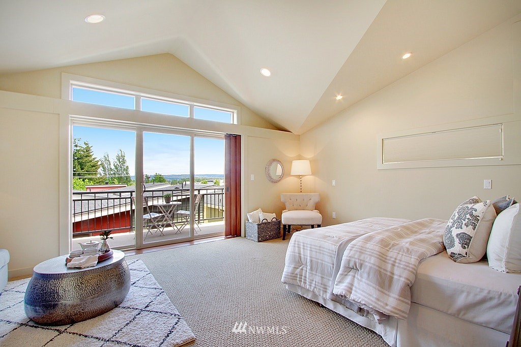 7757 Sand Point Way Northeast, Unit A Seattle, WA 98115 - Photo 13 of 25 a bedroom with a bed and a couch