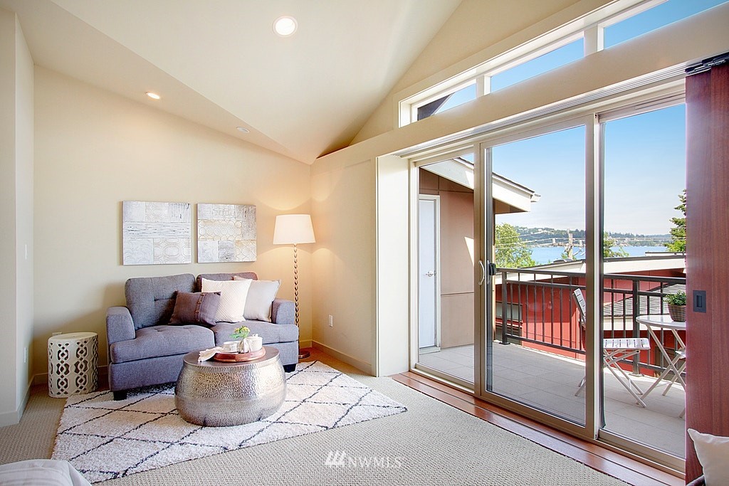 7757 Sand Point Way Northeast, Unit A Seattle, WA 98115 - Photo 15 of 25 a living room with furniture and a floor to ceiling window