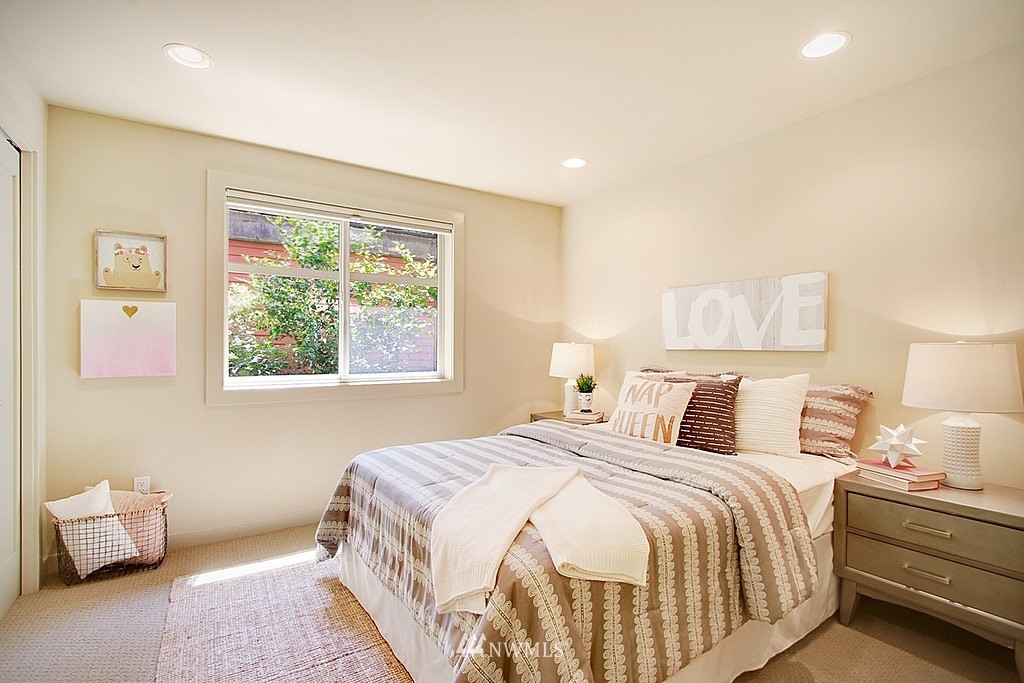 7757 Sand Point Way Northeast, Unit A Seattle, WA 98115 - Photo 18 of 25 a bedroom with bed and a window
