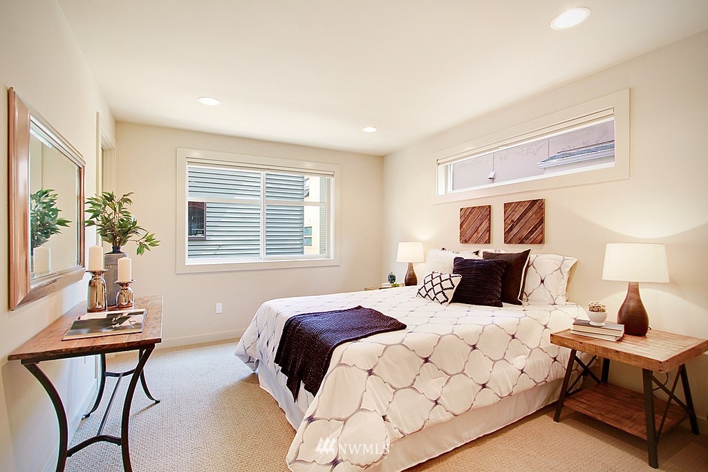 7757 Sand Point Way Northeast, Unit A Seattle, WA 98115 - Photo 19 of 25 a bedroom with a bed and a table