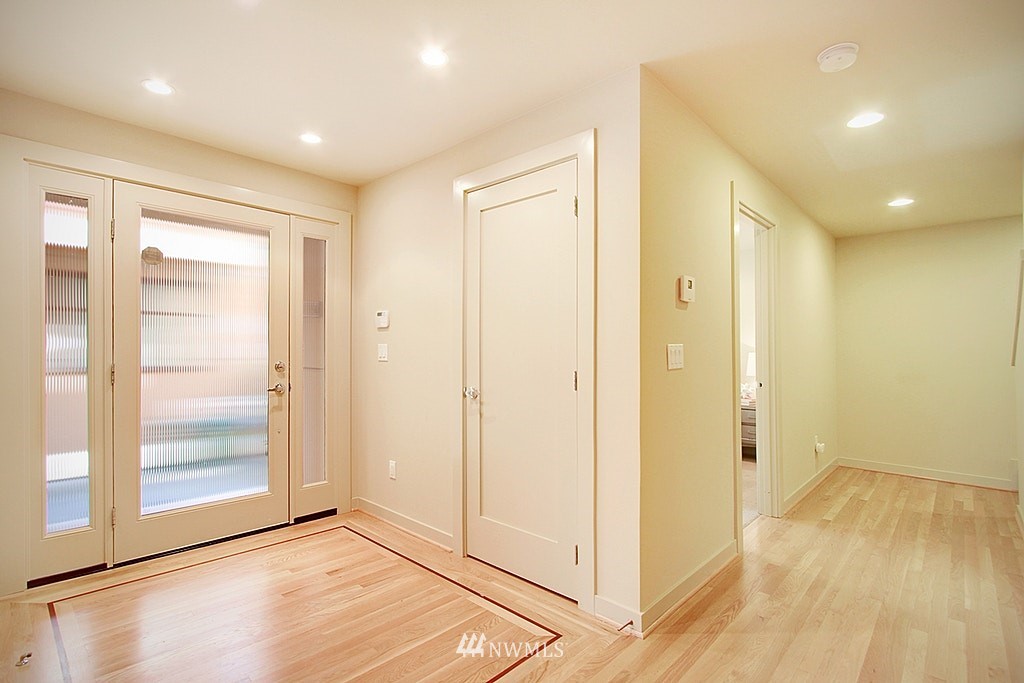 7757 Sand Point Way Northeast, Unit A Seattle, WA 98115 - Photo 21 of 25 a view of livingroom with wooden floor