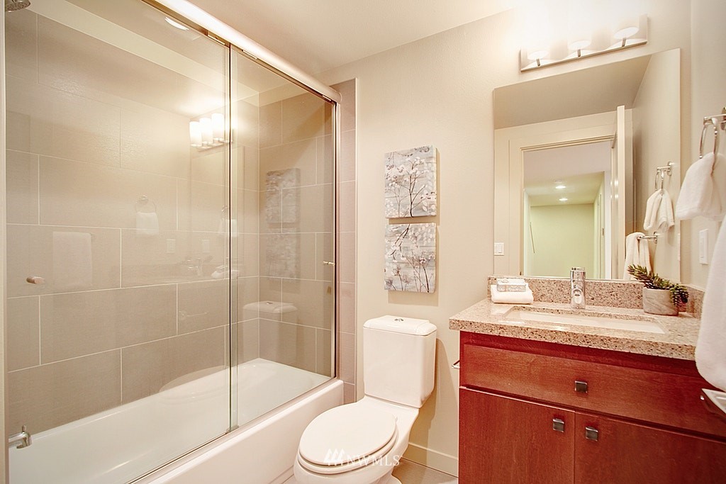 7757 Sand Point Way Northeast, Unit A Seattle, WA 98115 - Photo 22 of 25 a bathroom with a sink a toilet and shower