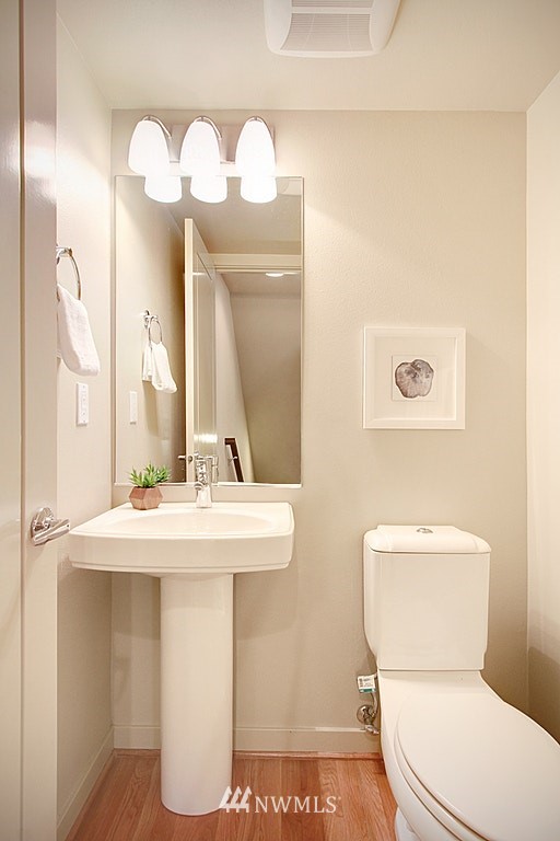 7757 Sand Point Way Northeast, Unit A Seattle, WA 98115 - Photo 23 of 25 a bathroom with a sink a toilet and a mirror