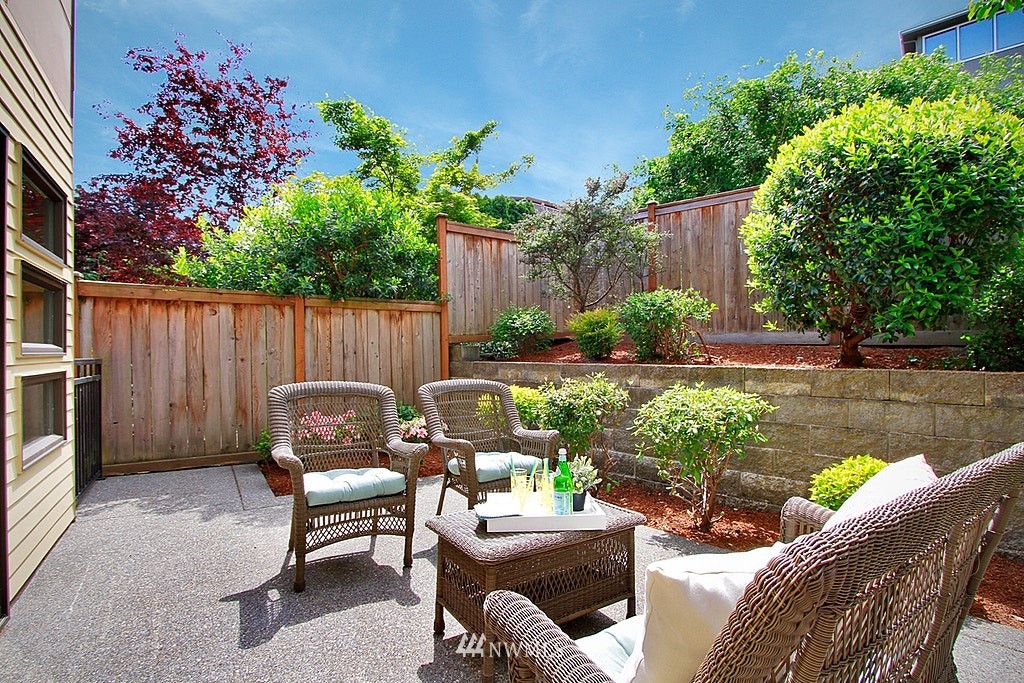 7757 Sand Point Way Northeast, Unit A Seattle, WA 98115 - Photo 24 of 25 a backyard of a house with outdoor seating