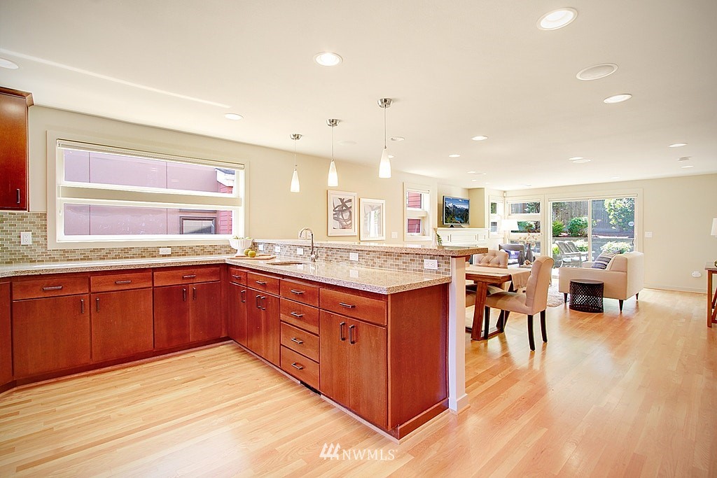 7757 Sand Point Way Northeast, Unit A Seattle, WA 98115 - Photo 6 of 25 a large kitchen with stainless steel appliances granite countertop a large counter top a sink and a refrigerator