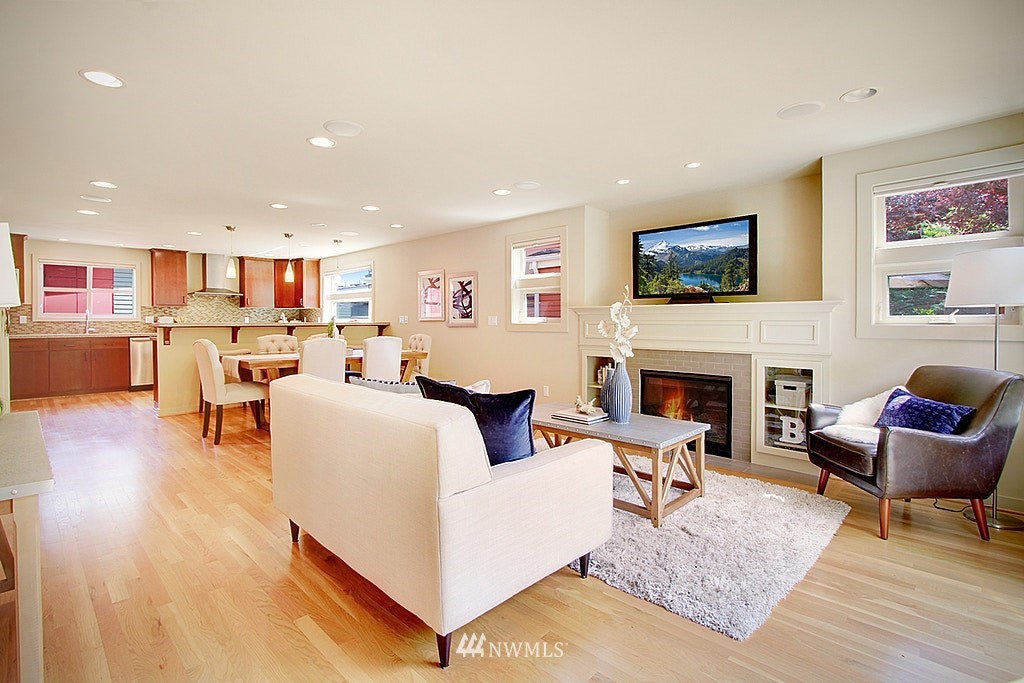 7757 Sand Point Way Northeast, Unit A Seattle, WA 98115 - Photo 9 of 25 a living room with furniture and a fireplace